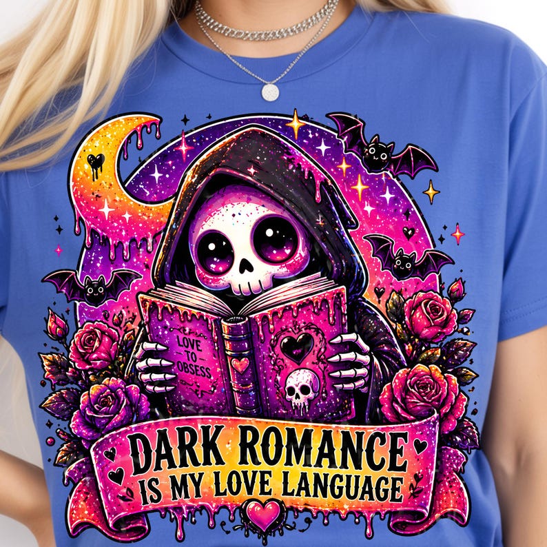 May include: Blue t-shirt featuring a cartoon Grim Reaper reading a book with the text "Love to Obsess" and "Dark Romance is My Love Language." The design includes bats, roses, a crescent moon, and a skull.