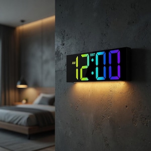 May include: A black digital wall clock displaying 12:00 AM with a gradient of green, blue, and purple. The clock is rectangular and mounted on a gray textured wall. The word "DST" is visible above the time.