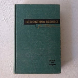 May include: A teal green hardcover book titled "Introduction to Business for Colleges" by Puckett and Beighley.