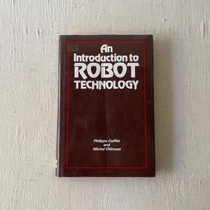 May include: A brown book with the title "An Introduction to Robot Technology" by Philippe Coiffet and Michel Chirouze.