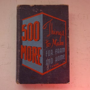 May include: A vintage book cover with a red and blue design. The title is "500 Things to Make for Farm and Home Cook Book".