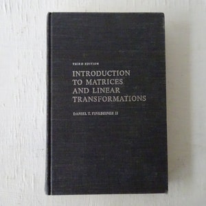 May include: A black hardcover book with the title "Introduction to Matrices and Linear Transformations" and the author "Daniel T. Finkbeiner II" printed in white on the front cover. The book is a third edition.