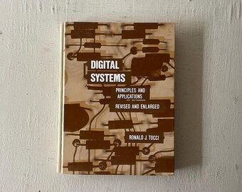 May include: A brown book titled "Digital Systems: Principles and Applications, Revised and Enlarged" by Ronald J. Tocci. The cover features a circuit board design.