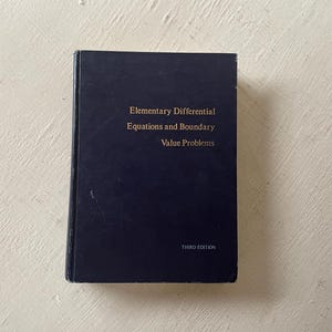 May include: A navy blue hardcover book titled "Elementary Differential Equations and Boundary Value Problems, Third Edition".