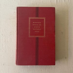 May include: A red hardcover book with the title "McGraw-Hill Physical and Quantum Electronics Series" on the front cover.