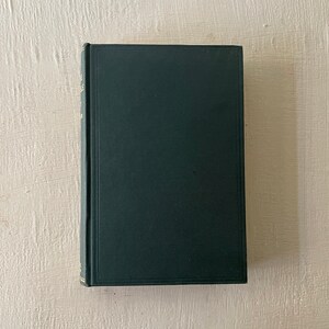 May include: A dark green hardcover book with gold lettering on the spine.