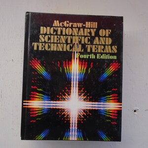 May include: A black book with a gold title that reads "McGraw-Hill Dictionary of Scientific and Technical Terms Fourth Edition". The cover features a colorful abstract design with a bright white light in the center.