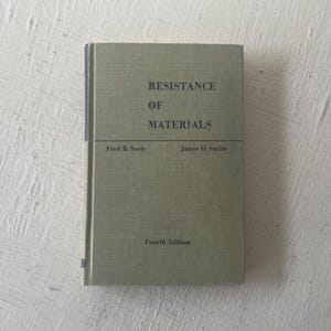 May include: A green book titled "Resistance of Materials" by Fred B. Seely and James O. Smith. The book is the fourth edition.