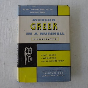 May include: A yellow, blue, and black book cover with the title "Modern Greek in a Nutshell" and the subtitle "Illustrated". The cover also includes the text "Easy - Concise - Authoritative - All You Need to Know" and "Research & Development by Institute for Language Study".