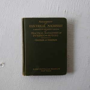 May include: A green book titled "Management of Electrical Machinery" with gold lettering. The book is a revised and enlarged edition of "Practical Management of Dynamos and Motors" by Crocker and Wheeler. It was published by D. Van Nostrand Company in New York.