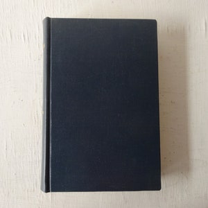 May include: A dark blue hardcover book with a plain cover.