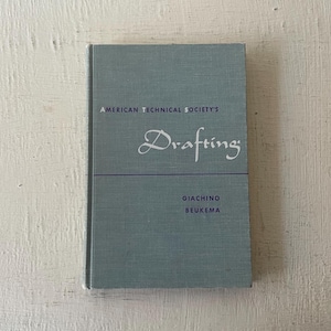 May include: A blue book with the title "Drafting" in white cursive lettering. The book is from the American Technical Society and is authored by Giacchino and Beukema.