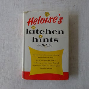 May include: A vintage book titled "Heloise's Kitchen Hints" by Heloise. The cover features a yellow and red design with a stylized flower illustration and the text "Easy ways to save time, money and energy. Where and how to shop... how to cook better and faster... food storage... tested ways to clean and brighten your kitchen and make it a palace instead of a prison."