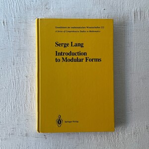 Peut inclure: Un livre jaune intitulé "Introduction aux formes modulaires" de Serge Lang. Le livre fait partie de la série "Grundlehren der mathematischen Wissenschaften" et est publié par Springer-Verlag.