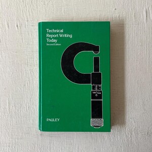May include: A green book titled "Technical Report Writing Today, Second Edition" by Pauley. The cover features a black and white illustration of a caliper.