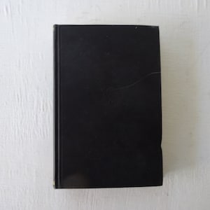 May include: A black hardcover book with a gold embossed design on the front cover.