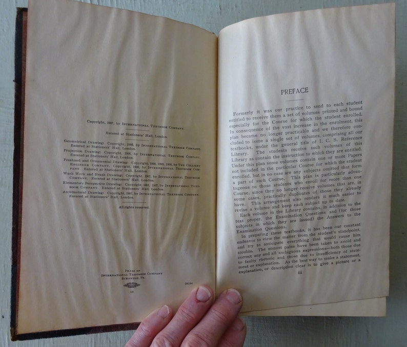 May include: An open book with a preface page titled "Preface". The page discusses the changes made to the book's format and the benefits of the new format for students. The copyright information for the book is on the left page.