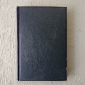 May include: A dark blue hardcover book with a textured cover.