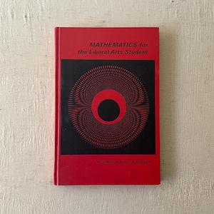 May include: Red hardcover book with the title "Mathematics for the Liberal Arts Student" and the author's names "Richman, Walker, & Wisner". The cover features a black and red geometric design.