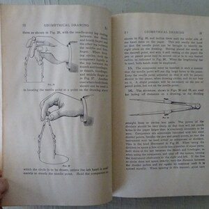 May include: A black and white illustration of a hand holding a pair of compasses. The compasses are used for drawing circles. The illustration shows the correct way to hold the compasses to draw a circle.