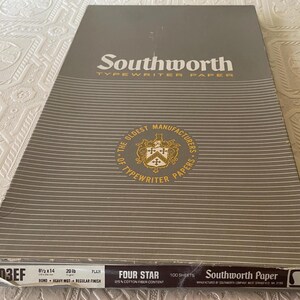 May include: A package of Southworth Typewriter Paper, featuring a gray and white striped design. The packaging includes the text "Southworth" and "Typewriter Paper," along with details about the paper's size (8.5 x 14 inches), weight (20 lb), and quantity (100 sheets).