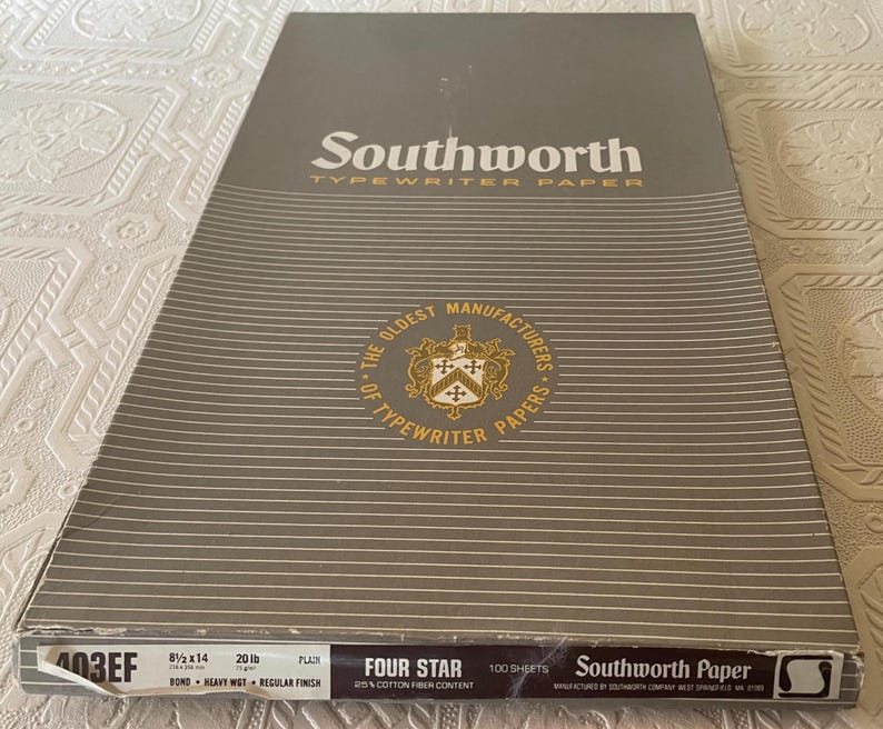 May include: A package of Southworth Typewriter Paper, featuring a gray and white striped design. The packaging includes the text "Southworth" and "Typewriter Paper," along with details about the paper's size (8.5 x 14 inches), weight (20 lb), and quantity (100 sheets).