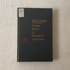 May include: A black hardcover book with gold lettering titled "Computer Methods for Mathematical Computations" by George E. Forsythe, Michael A. Malcolm, and Cleve B. Moler. The book is part of the Prentice-Hall Series in Automatic Computation.