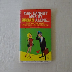 May include: Vintage paperback book titled "Man Cannot Live by Broad Alone..." with a red and green cover. The cover features a cartoon illustration of a man and woman. The book is edited by Phil Hirsch.
