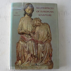 May include: A book titled "Masterpieces of European Sculpture" by Martin Hürlimann and Eric Newton. The cover features a golden sculpture of two figures, one sitting and the other reclining on their lap.