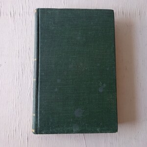 May include: A dark green hardcover book with gold accents on the spine.