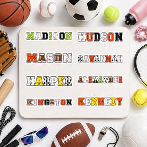May include: A rectangular board displaying eight custom name stickers featuring sports-themed typography. The names Madison, Hudson, Mason, Savannah, Harper, Alexander, Kingston, and Kennedy are printed in block letters filled with patterns of basketballs, baseballs, and soccer balls.