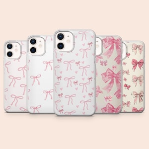 May include: A collection of five phone cases with various pink bow patterns. The cases have a clear or white background, with the bows in different sizes and arrangements. Some cases feature hearts. The overall aesthetic is feminine and delicate.