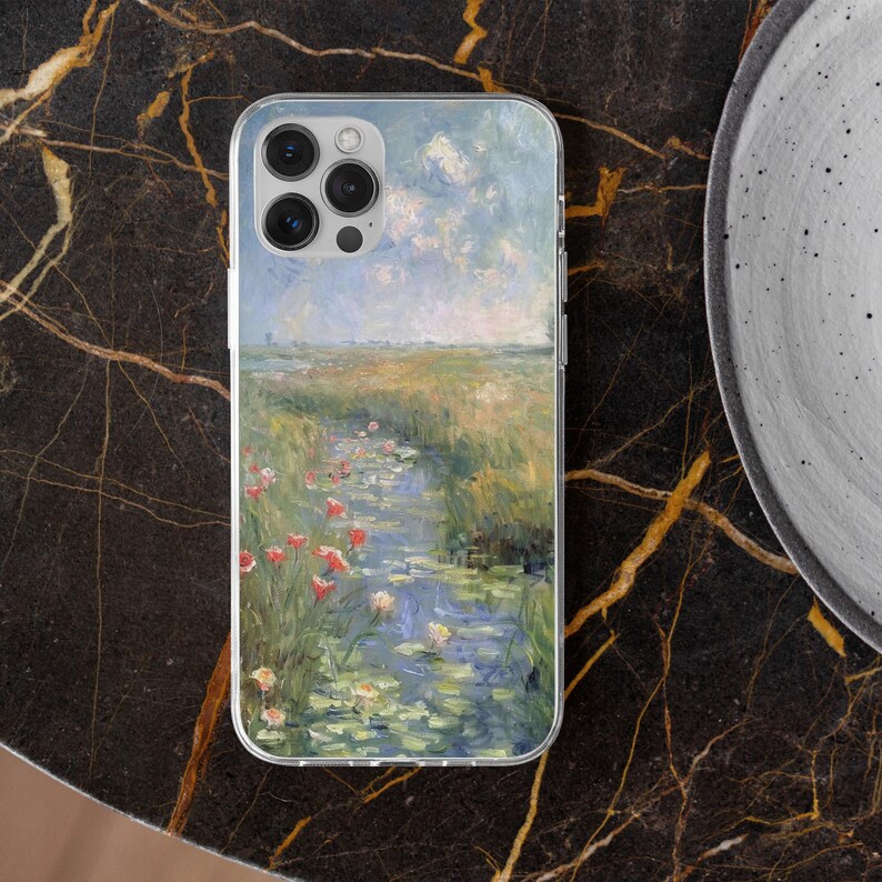 May include: Clear phone case featuring a landscape painting with a water stream, red flowers, and a cloudy sky. The case has a clear border and a camera cutout.