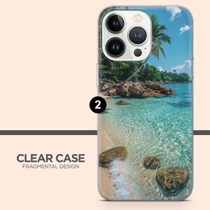 May include: Clear phone case with a tropical beach scene. The case features a vibrant image of a sandy beach, clear turquoise water, rocks, and a palm tree under a blue sky. The text "CLEAR CASE FRAGMENTAL DESIGN" is printed on the case.