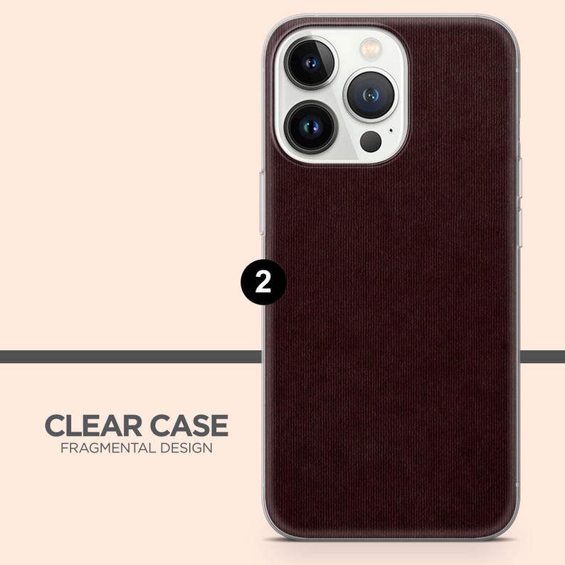 May include: A clear phone case with a burgundy textured back. The case has a clear border and protects the phone's camera. The text "CLEAR CASE FRAGMENTAL DESIGN" is printed at the bottom.