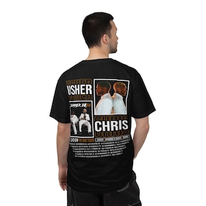 May include: A black short-sleeve t-shirt featuring a graphic print on the back. The design includes the text USHER and CHRIS, images of two performers, the text SUMMER 2026, and a list of tour dates for THE R&B TOUR USHER RAYMOND & CHRIS BROWN.