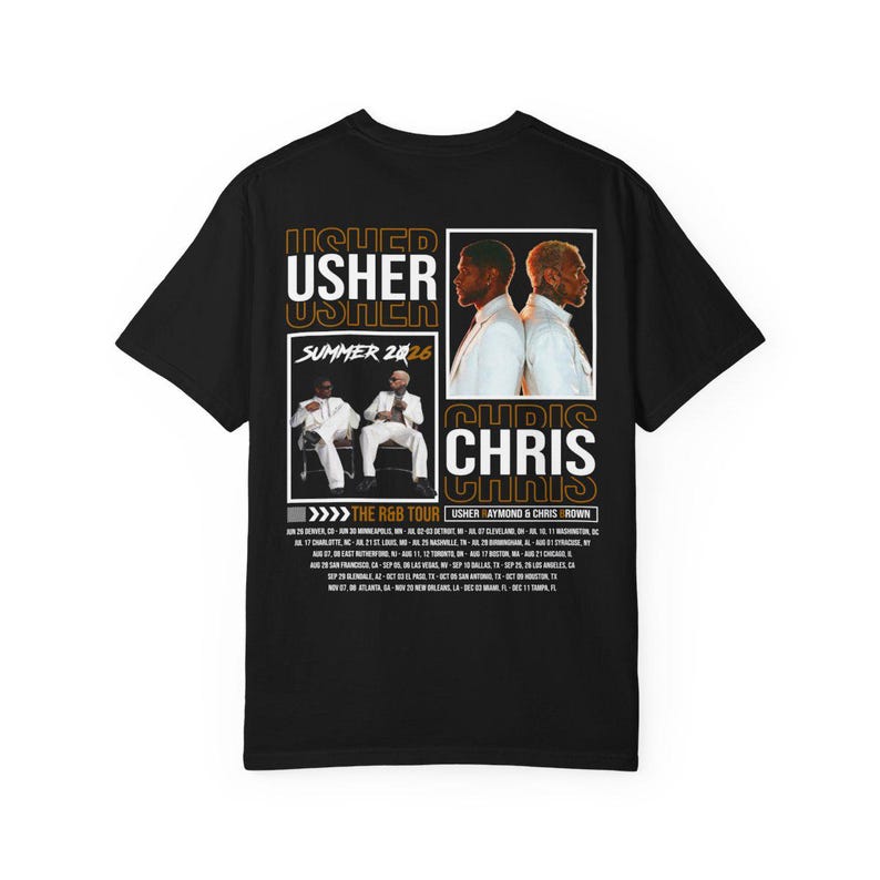 May include: A black t-shirt featuring a graphic print with the text USHER and CHRIS. The design includes two photographic panels of the artists in white suits, the text SUMMER 2026, and a list of tour dates for The R&B Tour with Usher Raymond.