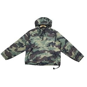 May include: Camouflage anorak jacket with a hood, a front pocket, and a half-zip closure. The jacket features a green, brown, and black camouflage pattern. The jacket has long sleeves and a drawstring at the bottom.