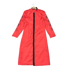 May include: A long, red coat with black trim down the front and on the collar. The sleeves have black Japanese characters embroidered on them. The coat is hanging on a wooden hanger.
