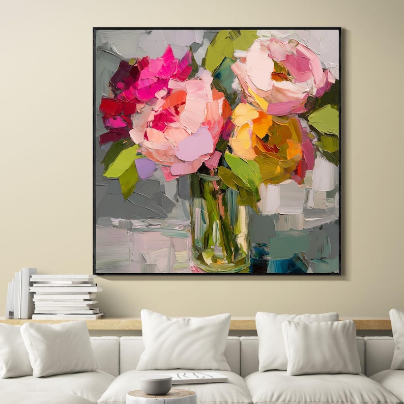 May include: An oil painting of a bouquet of flowers in a clear glass vase. The flowers are in shades of pink, orange, and yellow, with green leaves. The painting is in a black frame and has a textured appearance.