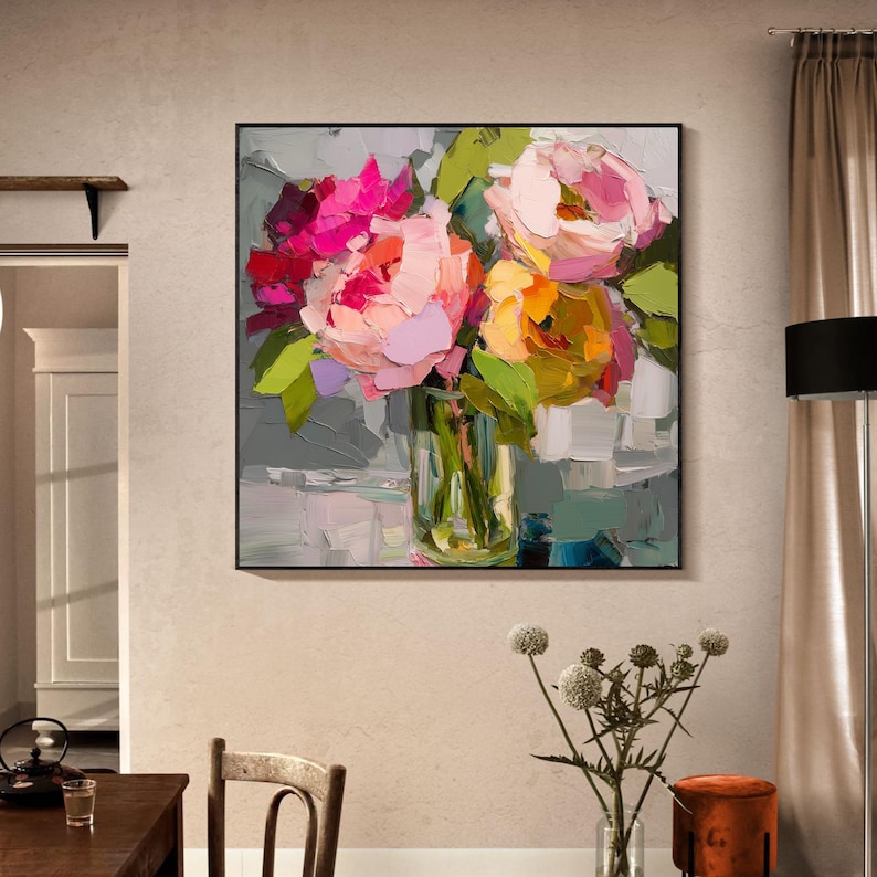 May include: A framed floral painting featuring a bouquet of vibrant flowers in a clear glass vase. The flowers are painted with thick brushstrokes in shades of pink, yellow, and green, set against a gray and white background.