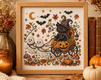 May include: A square cross-stitch embroidery in a light wood frame depicting a black cat wearing a purple witch hat, sitting in a pumpkin carriage pulled by two white ghosts. The scene includes bats, a crescent moon, autumn leaves, and mushrooms.