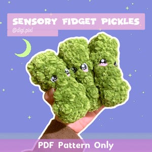 May include: Three plush green sensory fidget pickles with embroidered eyes and pink accents are held in a hand. The image has text that reads "SENSORY FIDGET PICKLES" and "PDF Pattern Only" on a purple background.