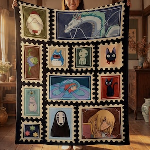 May include: A large, rectangular blanket featuring a patchwork design of various anime characters in postage stamp-like frames. The blanket has a black border and a cream-colored background. The characters include a dragon, a cat, and other animated figures.