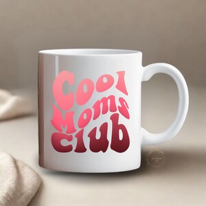 May include: A white ceramic mug with a black handle and the text "But First, Coffee" in a black, bold font. The mug is sitting on a white surface. The mug is 4 inches tall.