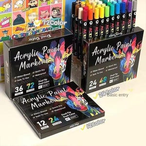 May include: Three black boxes of acrylic paint markers featuring a colorful giraffe illustration. The boxes display text including Acrylic Paint Markers, Water-Based, Quick Dry, Safe To Use, Waterproof, and Dual-Tip Dual-Color, with pack and color counts.