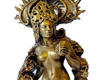 May include: A bronze-colored statue of a nude woman with a sun-like crown and flowing hair. She holds a pomegranate and is encircled by a garland of roses and skulls. The statue is on a round base.