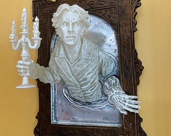 May include: A white ghostly figure emerges from a vintage ornate mirror frame, holding a candelabra with three lit candles. The figure is dressed in a white shirt and jacket, with a distressed, ghostly appearance. The mirror is surrounded by a dark brown wooden frame with intricate carvings.