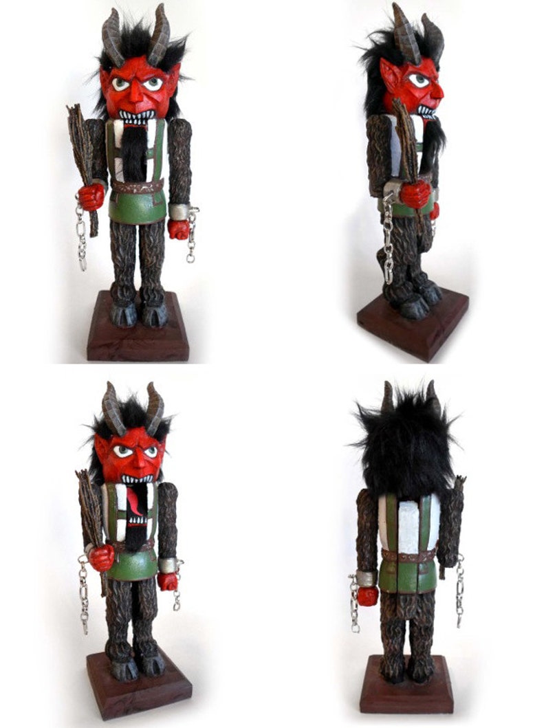 May include: A red and black wooden nutcracker with horns, a beard, and chains. The nutcracker is holding a stick in its right hand. The nutcracker is standing on a wooden base.