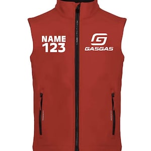May include: A red vest with a black zip and collar. The vest features the text "NAME 123" in white on the left chest and the "GASGAS" logo on the right. Two black zipped pockets are visible.